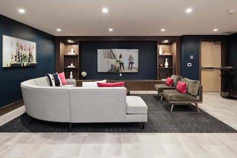 a living room with a couch and chairs and a tv